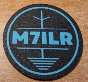 M7ILR drink mat black with sky blue text